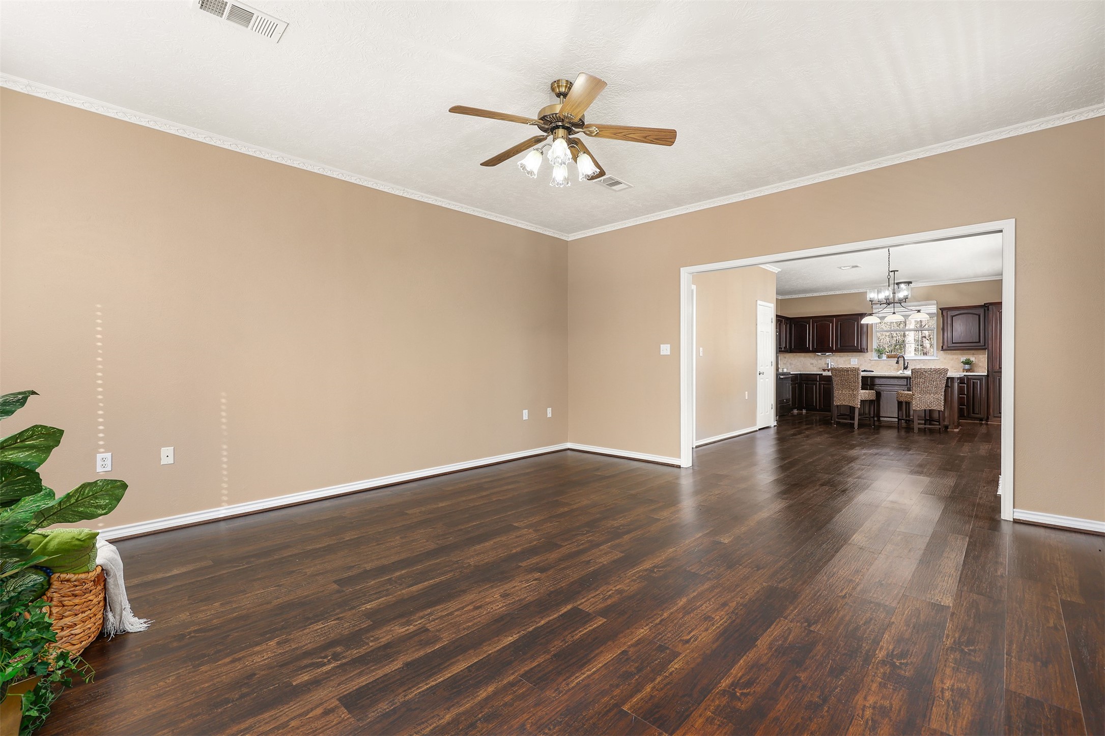1635 Wallisville-Turtle Bayou Road Wallisville, TX 77597 - Photo 23 of 46 a view of a livingroom with wooden floor and a ceiling fan