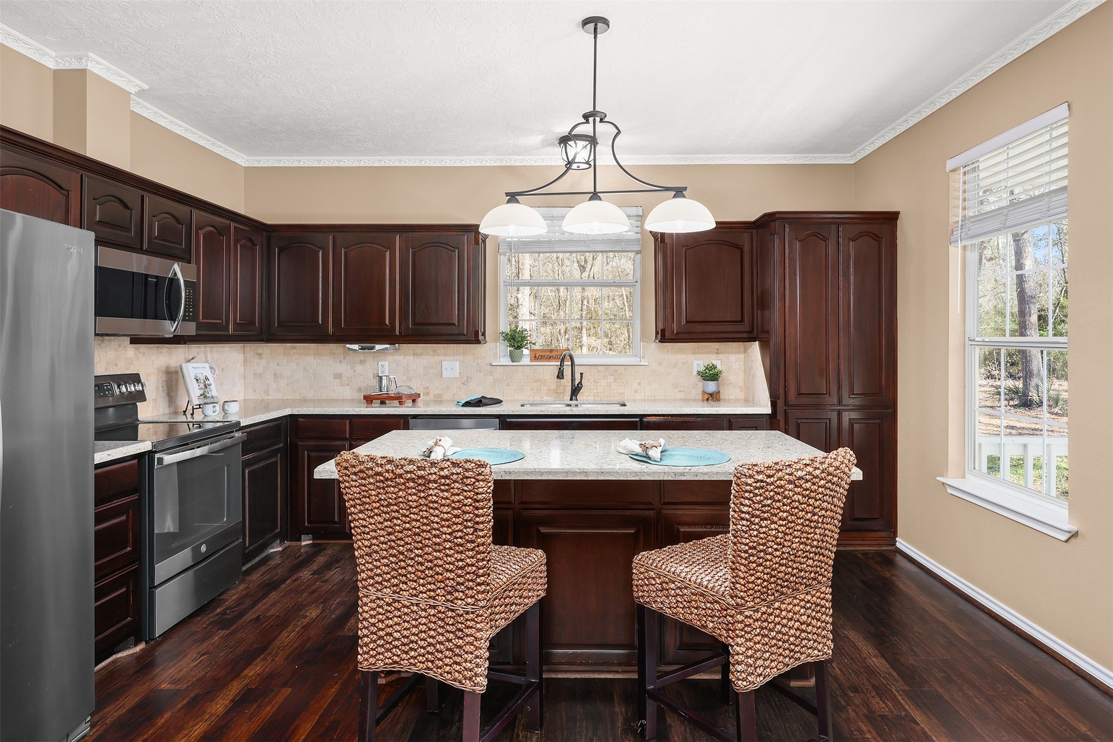 1635 Wallisville-Turtle Bayou Road Wallisville, TX 77597 - Photo 26 of 46 a kitchen with a wooden table chairs and refrigerator
