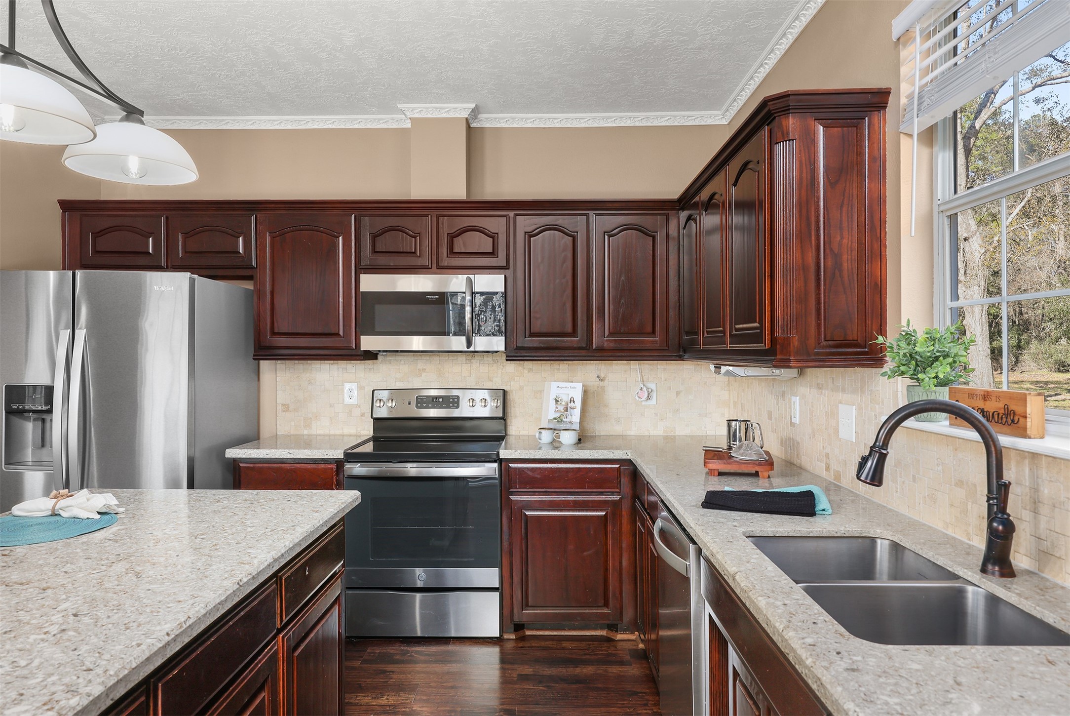 1635 Wallisville-Turtle Bayou Road Wallisville, TX 77597 - Photo 27 of 46 a kitchen with stainless steel appliances granite countertop a sink stove and refrigerator