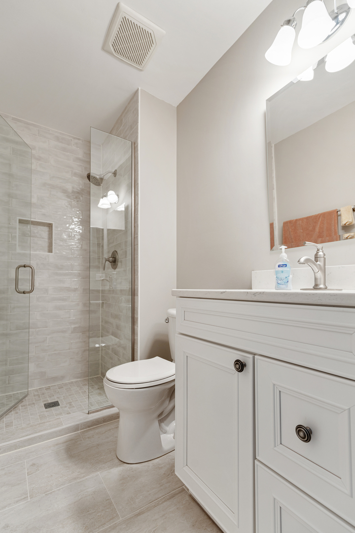 1600 Brittany Court, Unit C2 Wheeling, IL 60090 - Photo 15 of 27 a bathroom with a sink a toilet and shower