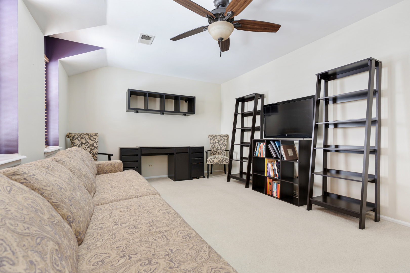 1600 Brittany Court, Unit C2 Wheeling, IL 60090 - Photo 17 of 27 a living room with furniture a air conditioner and a flat screen tv