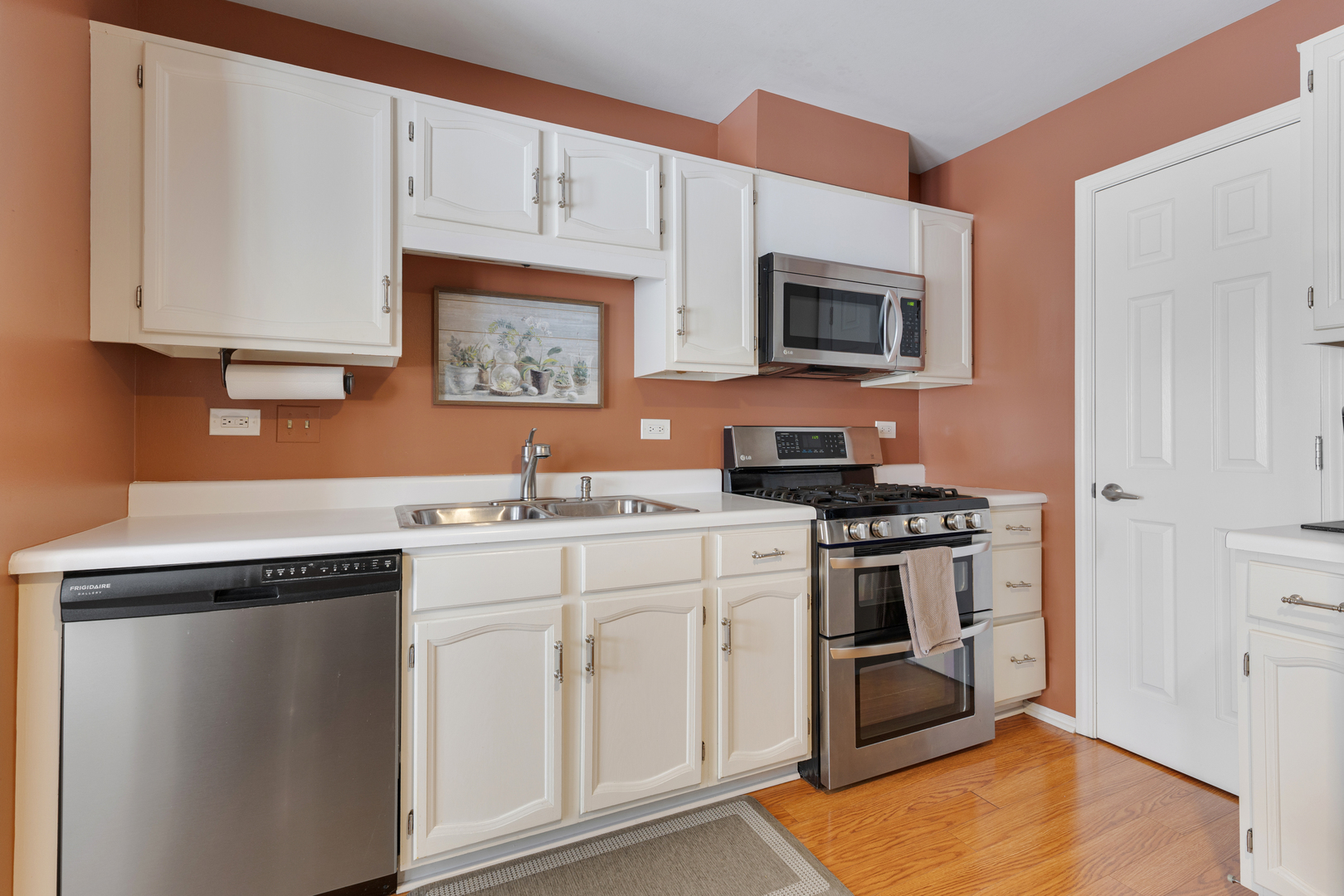 1600 Brittany Court, Unit C2 Wheeling, IL 60090 - Photo 8 of 27 a kitchen with stainless steel appliances granite countertop a stove a sink and a microwave