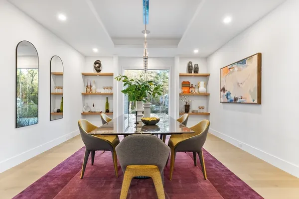 a view of a room with wooden floor and windows