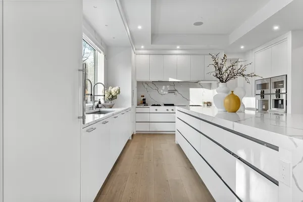 a kitchen with stainless steel appliances kitchen island granite countertop a stove and a refrigerator