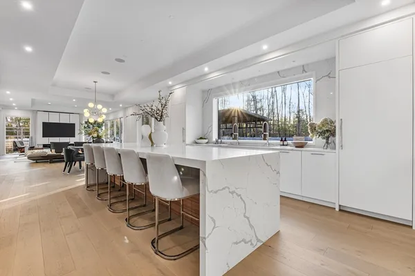 a kitchen with a table chairs sink and cabinets