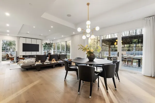 a view of a dining room with furniture and a chandelier