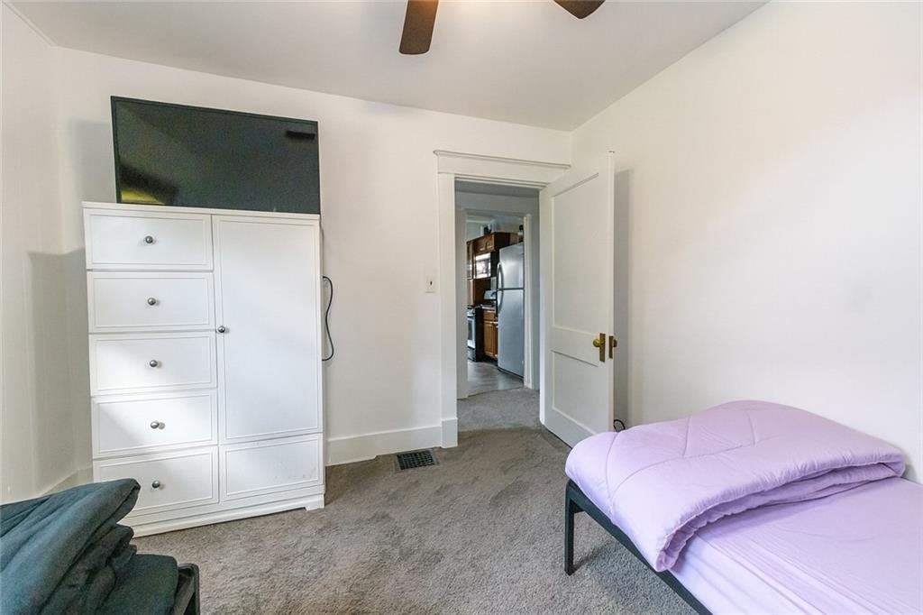 1470 Old Leechburg Road Pittsburgh, PA 15239 - Photo 11 of 25 a bedroom with a bed and a flat screen tv