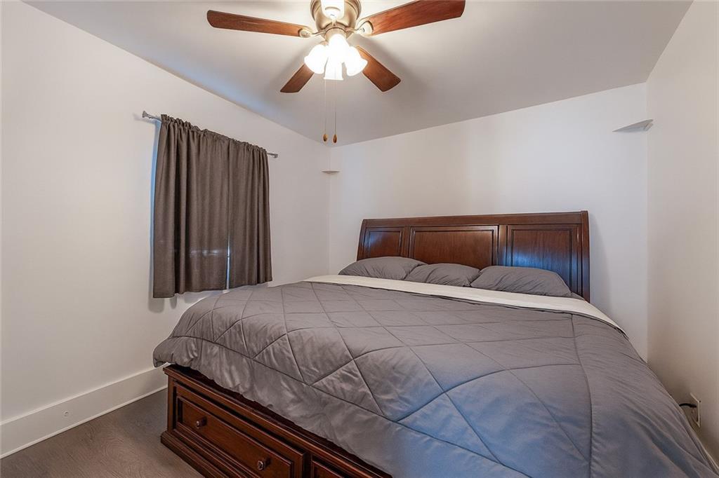 1470 Old Leechburg Road Pittsburgh, PA 15239 - Photo 8 of 25 a bedroom with a bed and a ceiling fan