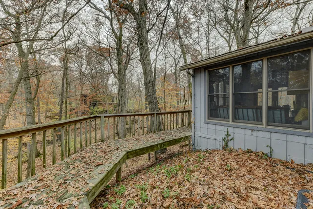 a view of balcony with wooden floor and fence