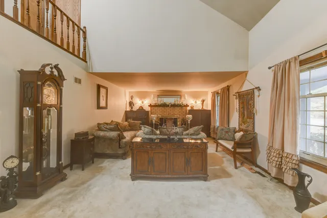 a view of living room filled with furniture and chandelier