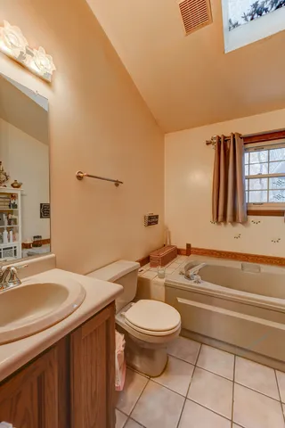 a bathroom with a sink a toilet and bathtub