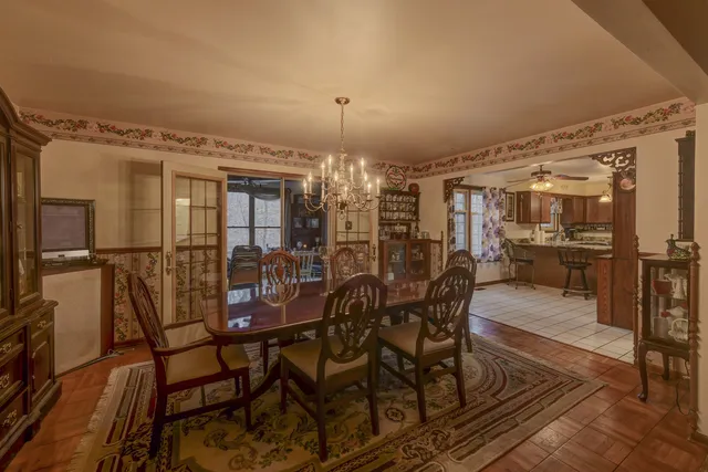 a view of a dining room with furniture and chandelier