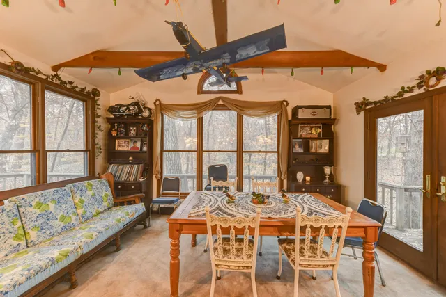 a dining room with furniture a chandelier and a rug