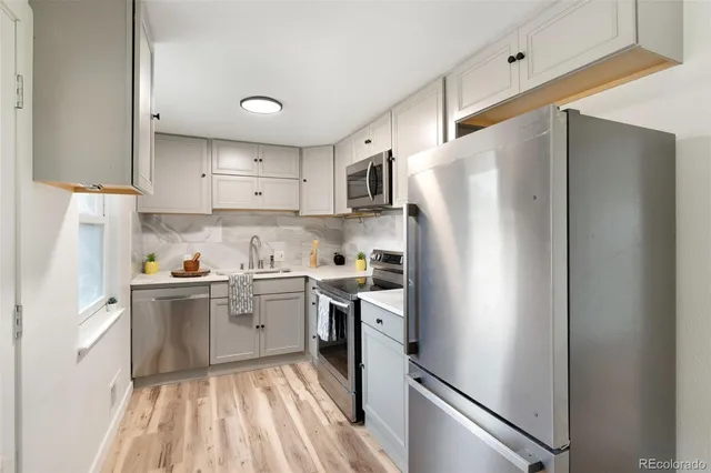 a kitchen with a refrigerator a sink and dishwasher