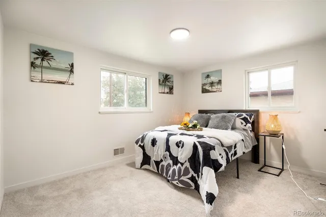 a bed sitting in a bedroom next to a window