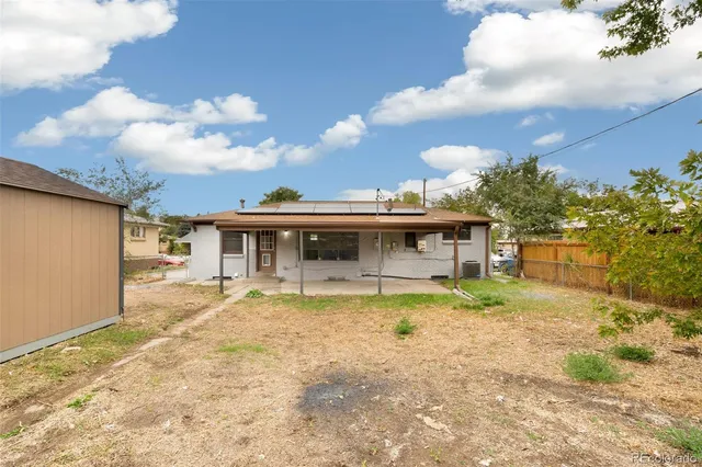 a view of a house with a yard and sitting area