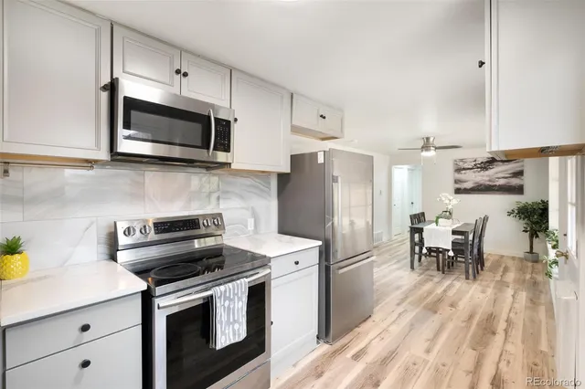 a kitchen with stainless steel appliances a stove sink microwave and cabinets