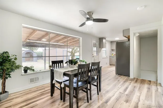 a view of a dining room with furniture window and wooden floor