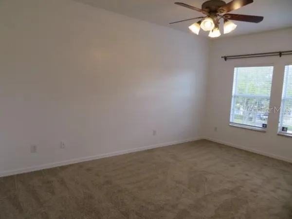 a bathroom with a toilet and a window