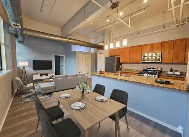 a view of a dining room with furniture a chandelier and wooden floor
