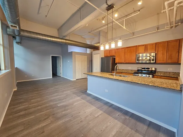 a view of kitchen with stove and cabinets