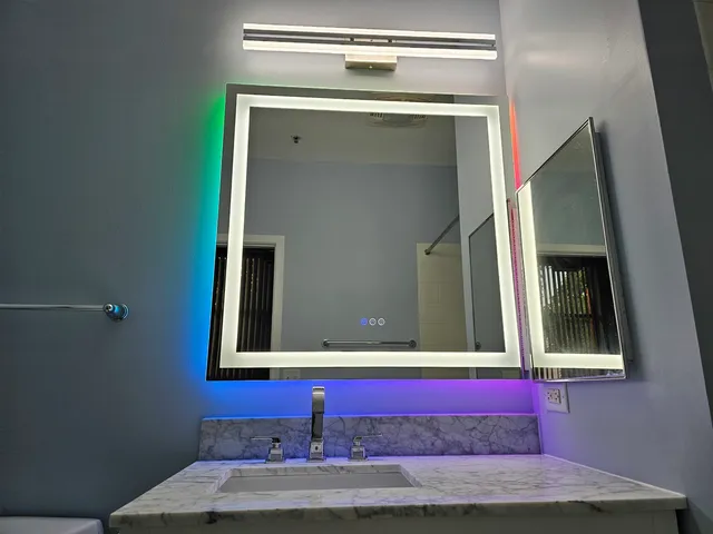 a bathroom with a mirror and a sink
