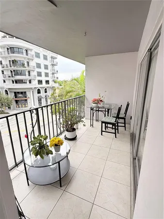 a view of a chairs and table in the balcony