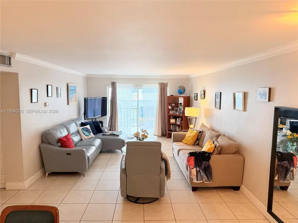 a living room with furniture gym equipment and a flat screen tv