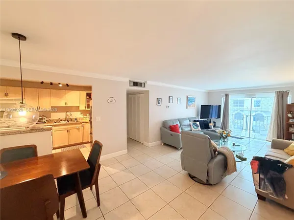 a living room with furniture and a kitchen view