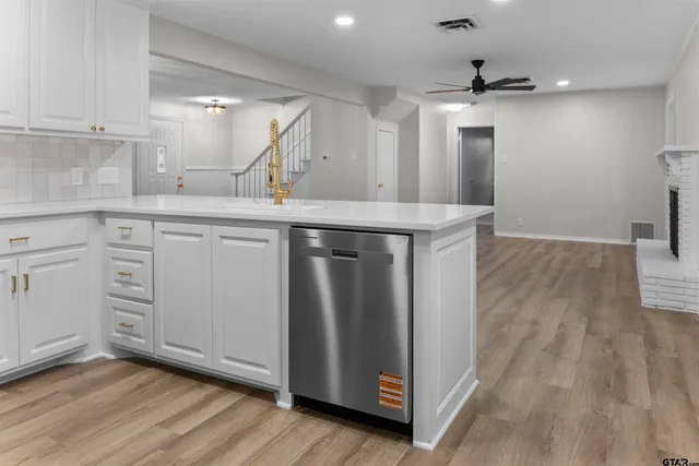 a kitchen with kitchen island a sink and wooden floor