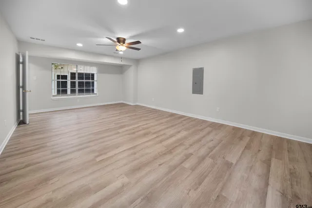 wooden floor in an empty room with a window