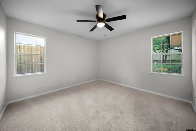 a view of a livingroom with a ceiling fan and window