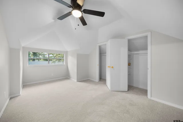 an empty room with windows and closet