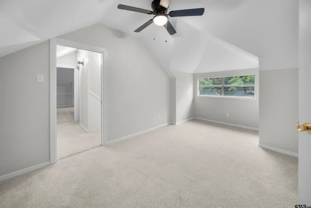a view of a kitchen with wooden floor and cabinets