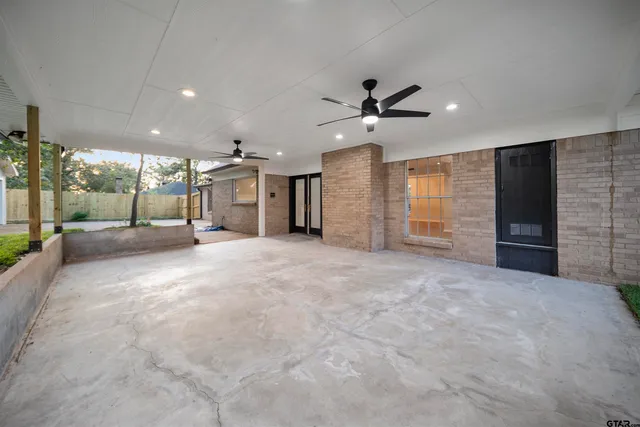 a view of a livingroom with a ceiling fan and window
