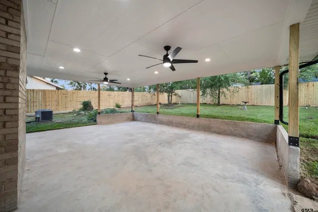 a view of a patio with table and chairs potted plants