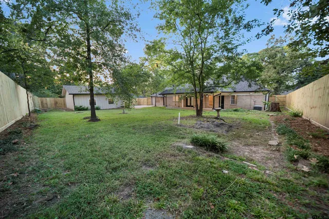 a front view of a house with a garden and yard