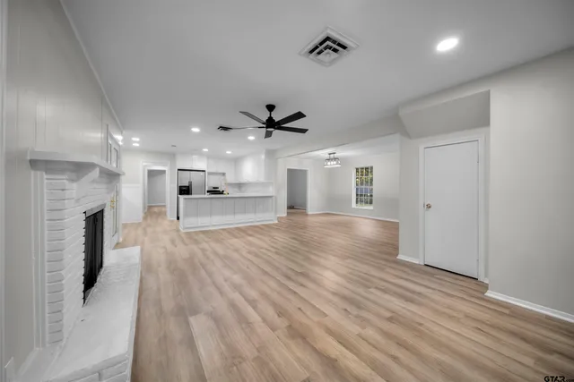 a view of a living room a kitchen and a wooden floor