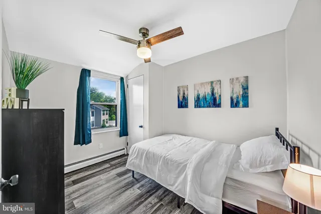 a bedroom with a bed and a large window