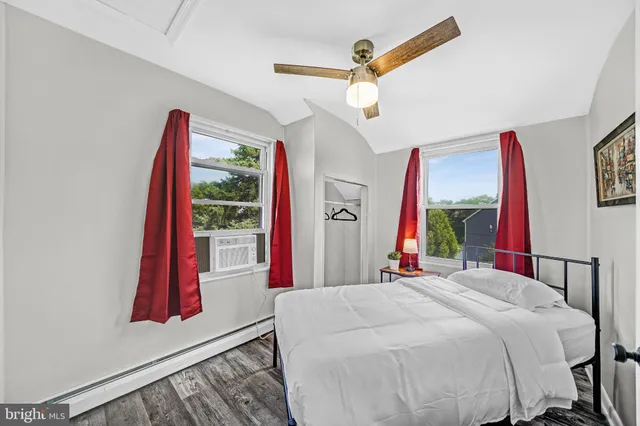 a bedroom with a large bed and a flat tv screen