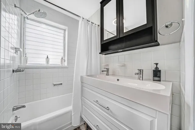 a bathroom with a sink a toilet and bathtub