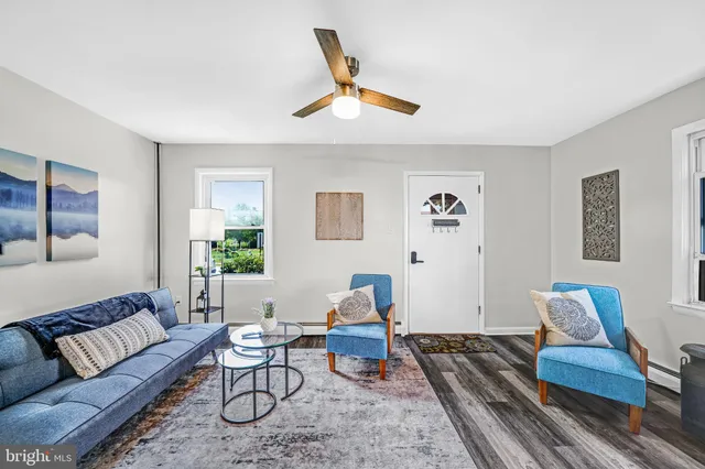 a living room with furniture and wooden floor