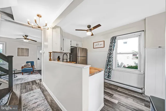a living room with furniture a dining table and a window
