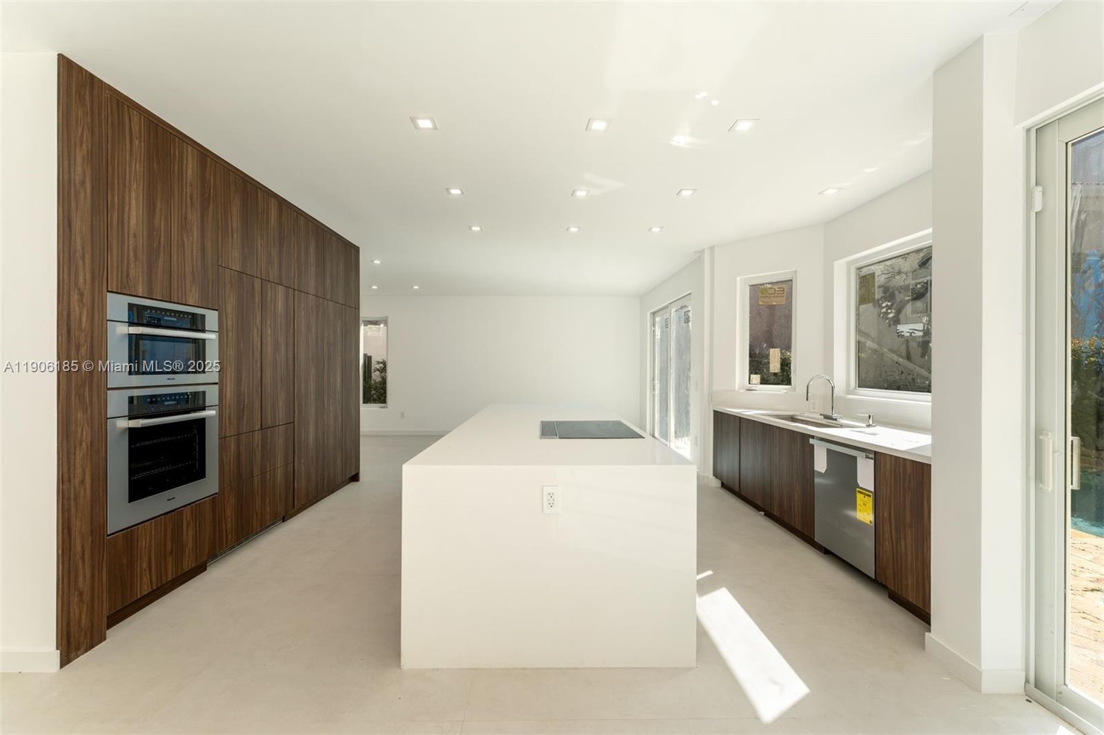 a large kitchen with a stove and a refrigerator