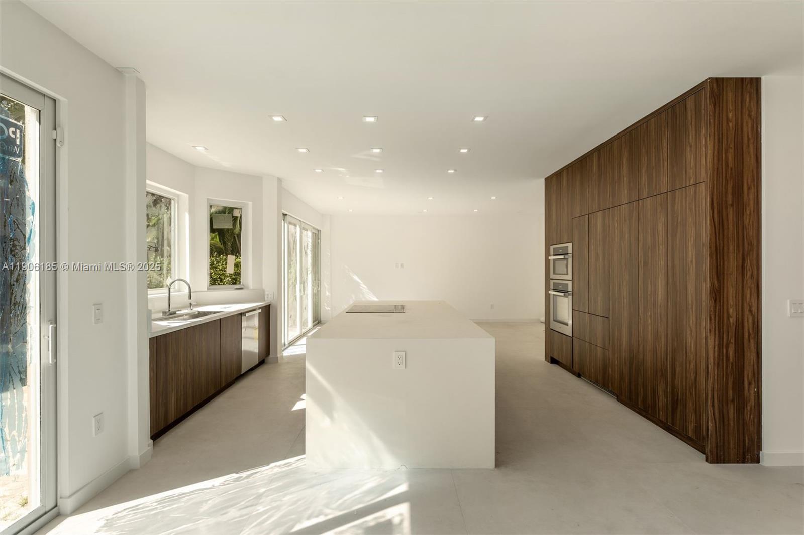3944 194th Trail Sunny Isles Beach, FL 33160 - Photo 3 of 20 a large white kitchen with a large window