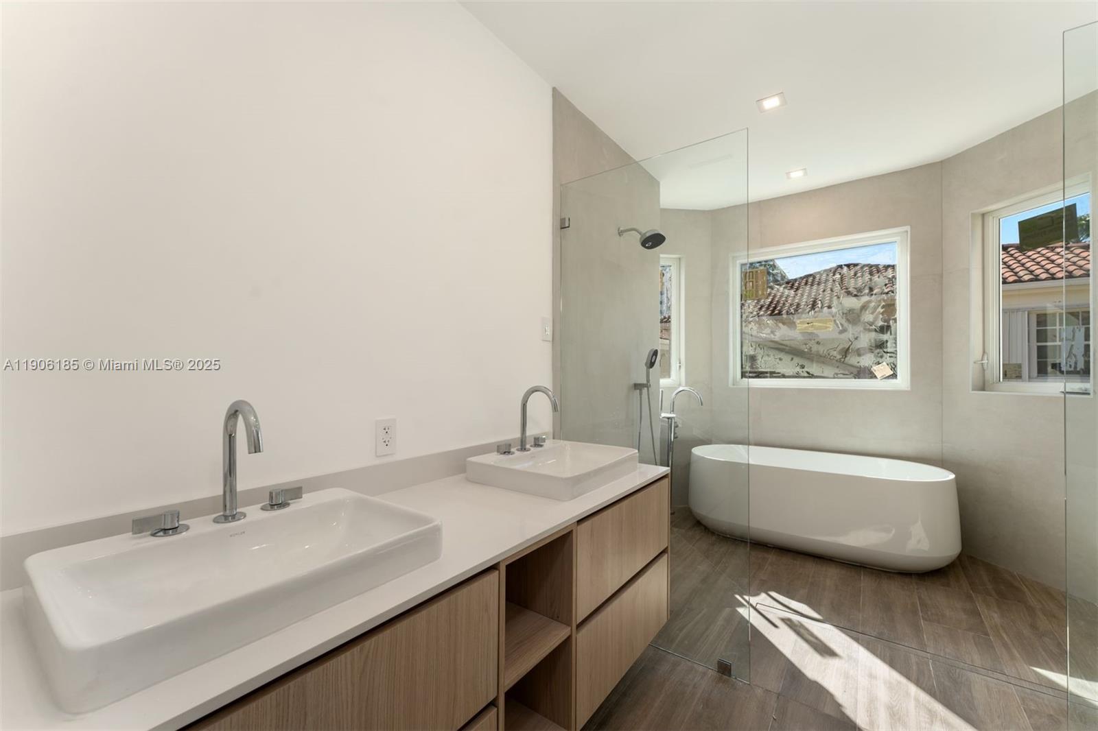 3944 194th Trail Sunny Isles Beach, FL 33160 - Photo 4 of 20 a bathroom with a double vanity sink and a bathtub