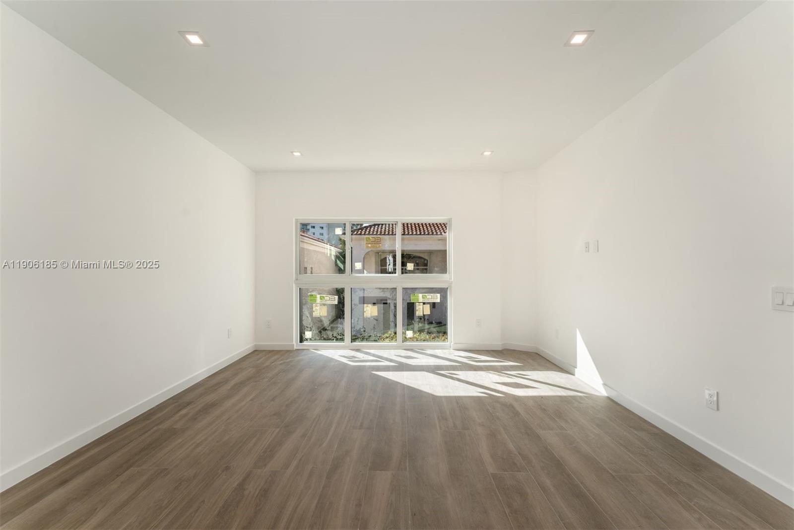 3944 194th Trail Sunny Isles Beach, FL 33160 - Photo 7 of 20 a view of an empty room with wooden floor and a window