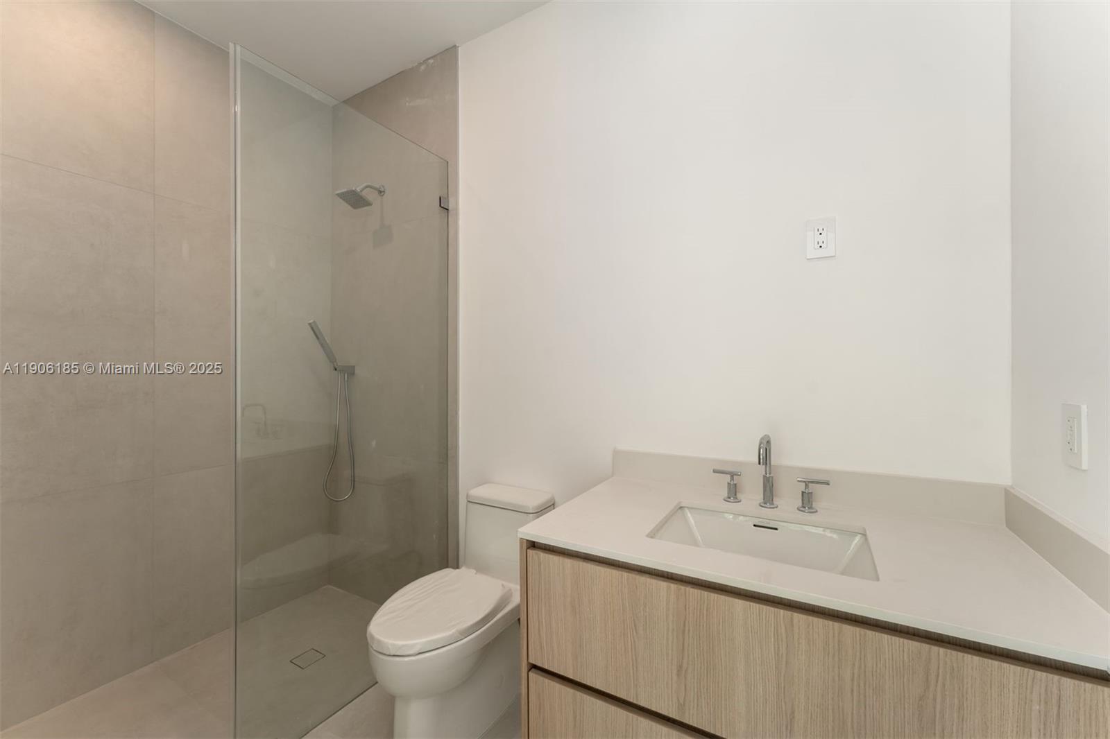 3944 194th Trail Sunny Isles Beach, FL 33160 - Photo 10 of 20 a bathroom with a granite countertop sink toilet and a mirror