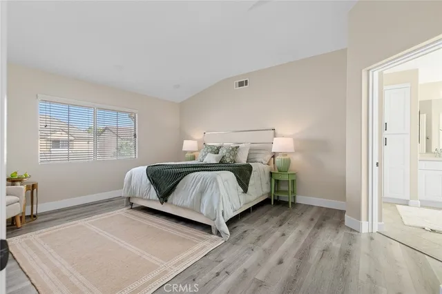 a bedroom with a bed and a couch