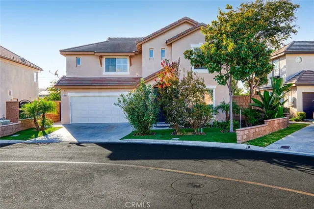a front view of a house with a yard and a garage